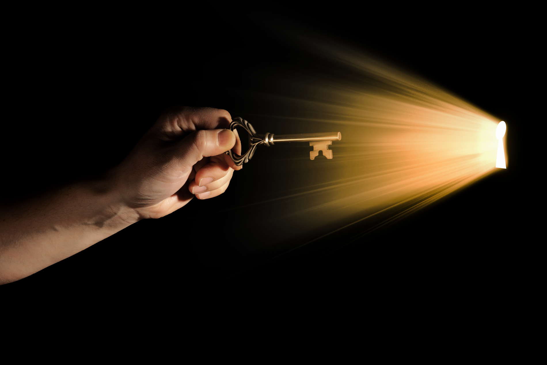 Hand with key reaching to a keyhole (stock image)