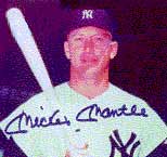 Signed photograph of professional baseball player Mickey Mantle in uniform and holding a bat.