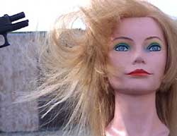 Figure 15 is a photograph of a shot causing a mannequin's hair to move.