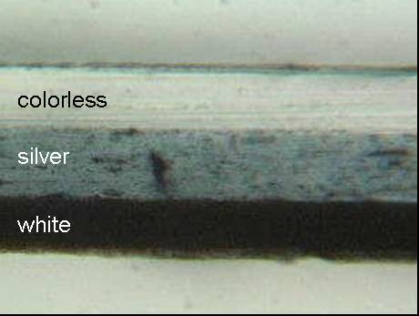 Figure 1 shows the micrograph of the cross section of tape Sample 55 magnified 250 times. The backing appears to have three layers.