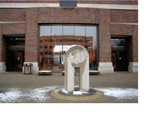 This image is the outside of a brick office building with a sculpture in front (as depicted in Figure 1).