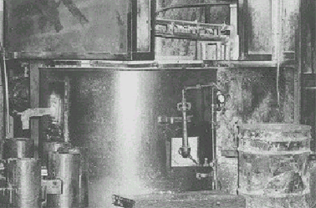 Photograph of ingots of a pot containing source (melt) of lead at bullet manufacture.