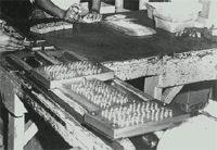 Photograph of cartridges packed into boxes stamped with coded assembly date.