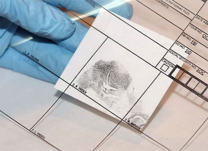 Figure 9 is an adhesive lifter affixed to the correct fingerprint block of a transparent ten-print card.