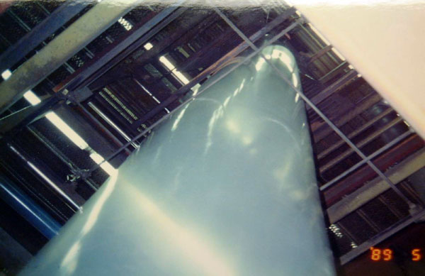 Figure 2: A photograph of a plastic column reaching several stories high that will be transformed into a bag