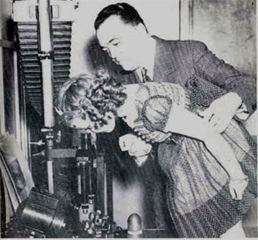 A historical photo of Director J. Edgar Hoover showing actress Shirley Temple a comparison microscope in the Laboratory