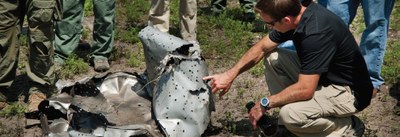 Investigators in the Field Examining Wreckage