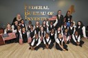 On May 20, 2013, members of the Seven Hills Charter School Choir visited the Boston FBI to sing a song they wrote especially for the Bureau. The song—“Hero”—was written to thank FBI personnel for their heroic work during the Boston Marathon bombings. In the photograph, Boston Division Special Agent in Charge Rick DesLauriers poses with choir members after their performance.  