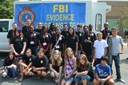 In July, the Charlotte FBI’s Evidence Response Team participated in the Central Piedmont Community College Forensic Kids Kamp featuring upcoming sixth through 12th graders. During the event, students took part in exercises that include techniques used in forensic laboratory and crime scene processing. Members of the Evidence Response Team demonstrated various crime scene investigation techniques, including laser trajectory, alternate light source, electro-static dust lifters, and students were able to practice developing and lifting fingerprints, along with casting and molding shoe impressions.