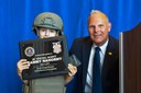 On June 9, 2014, employees of the FBI’s Chicago Division came together to show their support for 6-year-old Sammy Nahorny, the first patient at Comer Children’s Hospital to undergo high-dose radiation therapy for neuroblastoma, one of the deadliest pediatric cancers.   Sammy helped agents solve a mock bank robbery case and lead the SWAT team in making an arrest. At the end of the exercise, Sammy received an award from Special Agent in Charge Robert Holly for a job well done (above).