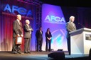 FBI Criminal Justice Information Services Division Unit Chief Steve Fischer addresses 2,000 football coaches at the 2011 American Football Coaches Association Conference in Dallas, Texas, on January 11, 2011. Fischer and FBI Community Outreach Specialist Bill Holley (far left) presented Kansas State Coach Bill Snyder (right) with a Director’s Award for his efforts in promoting the Child I.D. Program throughout the state of Kansas. Through the leadership of Snyder, more than 250,000 Child ID kits were distributed to kindergarten and first grade students. He raised the funds that made the distribution of the kits possible, arranged press conferences, and assisted with getting the Bureau in touch with individual schools. 