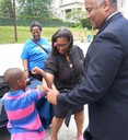 On August 7, 2013, FBI Philadelphia Community Outreach Specialist Natosha Warner and Special Agent Gregory A. Branch attended back-to-school events at the Families Forward Philadelphia Shelter, where a child showed off his muscles to Agent Branch and State Representative Vanessa Lowery Brown. 