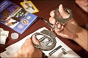 In October 2012, the FBI Springfield Division completed its most recent Citizens Academy. During the nine-week program, participants learned about the Bureau’s history, forensic techniques, and firearms training. They were also briefed on how the FBI investigates crimes in the U.S. and—when appropriate—overseas. Above, an academy participant examines handcuffs used by FBI agents.